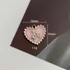 Nuevos accesorios de aleación con forma de corazón de perla colgante de ángel blanco y negro amor pendientes DIY materiales hechos a mano fabricantes al por mayor