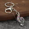 Llave de notas musicales creativas de lujo ligero europeo y americano Colgante pequeño Accesorios de joyería pequeños Rhinestone Metal Llavero para mochila Al por mayor