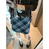 Además, la nueva minifalda de lana de estilo retro coreano para otoño, de cuadros, de cintura alta, entalladora y línea A, MQ1682
