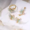 Anillo de Perla, Aretes, Colgante Juego de Tres Piezas con Diseño de Cristal de Goteo de Aceite de Mariposa Vacía, Lujo Ligero DIY de Gama Alta
