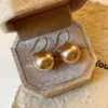 Zapatos de tacón alto color Dorado Champagne Perla Shijia de uso doméstico pendientes de gancho de oreja con perlas pendientes de temperamento de lujo ligero pendientes de otoño e invierno