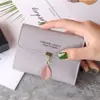 Nueva cartera pequeña femenina corta estudiante moda coreana pequeña fresca hoja tres pliegues hebilla monedero tarjetero mayoreo
