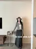 Saia de malha A-line com cintura elástica estilo coreano para mulheres, de caimento solto, com drapeado e comprimento médio, da Shenzhen Nanyou Women's Clothing