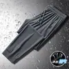 Calças de Seda Gelada Masculinas Verão Novo Secagem Rápida Longas Finas Largas Calças de Ar Condicionado Elásticas com Punho Tamanho Grande Casuais Esportivas