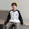 Camiseta de Manga Larga con Retazos Estilo Coreano de Moda para Niños Otoño 2026 Nueva Camiseta Básica Holgada para Niños para Primavera y Otoño