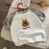 Camiseta de verano para niños de algodón puro de manga corta, diseño moderno estilo coreano con bloques de color, unisex, estampado de dibujos animados, top versátil de media manga para niños mayores