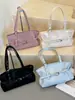Bolso de hombro de moda estilo coreano transfronterizo para mujer, nuevo modelo 2026, bolso simple para debajo del brazo, bolso tote de diseño versátil para el día a día