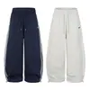 Pantalones de chándal anchos color blanco roto con raya lateral Bordado de logotipo pequeño Cintura con cordón Holgados Se pueden remangar Casual Deportivos Pantalones largos