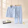 Nuevo conjunto de pijama de manga larga para niños de otoño e invierno 2026, con un conjunto de dos piezas engrosado y forrado de polar con cuello de solapa, adecuado tanto para niños como para niñas