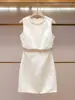 Colección de verano de alta gama para mujer de Shenzhen Nanyou: vestido elegante, de cuello redondo, muy adornado con pedrería, con flecos y ajustado sin mangas