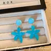 Dulces aretes florales amarillos, estilo vacación en la playa, efecto iluminador, aretes atmosféricos femeninos, tachuelas de estrella, estilo bosque