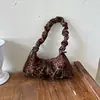 Transfronteriza, el bolso de mano de moda este año con forma de dumpling plisado para mujer, nuevo estilo 2026, con un lazo, bolso de hombro de lujo ligero, y se puede llevar bajo el brazo