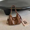 Bolsa de un solo hombro de moda de comercio exterior 2026 Nueva bolsa tote de gran capacidad Bolso multiusos simple retro Bolso de mano para el trabajo