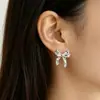 Pendientes de lazo dorado transfronterizos europeos y americanos, elegantes y modernos, con un diseño de alta gama y único, hechos de metal
