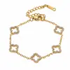 Conjunto de colar de aço inoxidável oco de trevo de quatro folhas mais vendido transfronteiriço, conjunto simples e versátil de colar, pulseira e brincos de aço titânio com zircônia