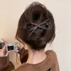 Um grampo de cabelo estiloso e versátil para mulheres, apresentando um design de bico de pato que não pressiona a parte de trás da cabeça, perfeito para criar penteados elegantes no outono e inverno.