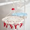 Tendedero de plástico con forma de flor de ciruelo de tres y dieciocho clips, resistente al viento y con múltiples clips para el hogar.