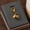 Colgante para llave de coche, bolso de gran sentido, accesorios de color dorado, oso, cereza, trébol de cuatro hojas, mariposa, bolso escolar, joyería al por mayor