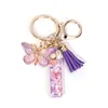 Llavero de Resina con Alfabeto Inglés A-Z Colgante de Borla de Mariposa Morada Colgante para Bolso de Mujer Llavero de Coche
