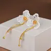 Pendientes largos con borla de estilo antiguo chino de magnolia 2024 nuevos pendientes de alto sentido de estilo nacional pendientes de temperamento nicho