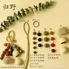 Kit de material DIY para fazer um móbile de casca de fruta, um sino pendurado de cura, com frutas pretas indonésias, estramônio, lírio d'água e rotim