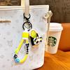 Llavero de zapatillas musicales de panda creativo que da vueltas, lindo colgante para mochila escolar, llavero para coche, agarra regalo pequeño al por mayor