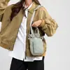 Bolsa de Ombro para Garrafa de Água Esportiva Leve Tendência ao Ar Livre para Mulheres 2026 Novo Modelo Bolsa de Mão com Múltiplos Bolsos Bolsa Transversal Versátil para Celular