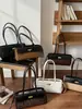 Bolsos transfronterizos 2026 nuevo moda vintage nicho casual bolso de hombro alta estética simple bolso de axila