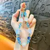 Cadena de llavero de cuentas de colores con luz UV creativa para teléfono móvil, colgante lindo para bolso, accesorios para funda de teléfono móvil, venta al por mayor
