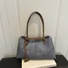 Bolso estampado de leopardo para mujer, gran capacidad, nuevo bolso casual de hombro o axila para principios de otoño de 2026, bolso tote de diseño único para el trabajo