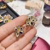 Pendientes de lujo calientes para transmisión en vivo Camelia chapados en oro de 18 quilates, totalmente de diamantes, con temperamento rico, aretes de tesoro de orquídea mariposa de colores para mujer