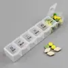 Caja de pastillas mini creativa de 7 compartimentos de plástico sub-empaque pastillas siete días a la semana pastillas para el cuidado de la salud caja de almacenamiento portátil caja de medicamentos