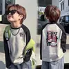 Camiseta de manga larga para niño para primavera y otoño 2026 nuevo modelo camiseta básica para niños mayores top de moda estilo callejero