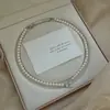 Collar de Perla de Cristal Perfectamente Redonda con Lazo y Perla de Zircón para Mujer, Diseño de Nicho de Lujo Ligero, Gargantilla Simple y de Gama Alta