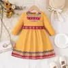 Comercio Exterior Venta al por mayor transfronteriza Vestido largo de manga larga para niña, estilo nuevo de primavera y otoño, con estampado Fair Isle, vestido de retazos