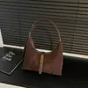 Al por mayor transfronterizo nuevo bolso de axila francés de nicho en forma de media luna para mujer, bolso de mano moderno de alta gama, bolso cruzado para el trabajo