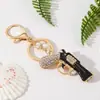 Chaveiro de pistola cravejado de diamantes transfronteiriço, pingente de chaveiro de carro em esmalte de liga, pingente de bolsa personalizado, presente
