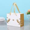 Bolsa de papel tridimensional de mano recubierta con estampado en caliente, impresión de logotipo personalizado, embalaje, bolsa de regalo, bolso de mano de regalo comercial, venta al por mayor