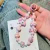 Nueva Cadena de Teléfono Móvil con Cuentas de Dibujos Animados Acrílicos Sanrio Mismo Estilo que Little Red Book Letra Pequeña Llave de Coche Al por Mayor