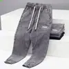 Calça Jogger Regular Lavada Tendência Primavera e Outono Jeans Juvenil Estiloso Versátil Solta Retalhos Cintura Média Cropped