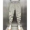 Calça casual masculina 2023 Verão nova solta seda gelada fina bonita versátil amarrada no tornozelo calça harém moda