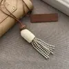 Collar de perlas con borlas en capas estilo coreano, moderno y versátil, cadena para la clavícula estilo vacacional, diseño de nicho, joyería de lujo ligero para mujer