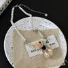 Collar moderno y elegante con borlas de oso de peluche y perlas para mujer, cadena de clavícula de lujo de alta gama, cadena de lana con nicho para el cuello.
