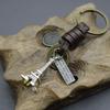 Llavero creativo para hombre, de aleación de bronce, con forma de torre pequeña, de piel de vaca tejida vintage.