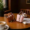 Colgante de minibolso cesta marca H, accesorio de llavero de coche de cuero, decoración linda y creativa para bolsa de auriculares
