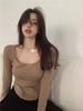 Otoño 2025 Nuevo Cuello U Color Sólido Sexy Escote Bajo Irregular Ajustado Manga Larga Camiseta Top de Capa Interior para Mujer