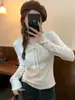 Tejido de hilo de núcleo retorcido Textura de cinta tejido de punto jacquard suéter para mujer cuello redondo corte ajustado versátil camiseta de manga larga
