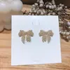 Pendientes elegantes de Dongdaemun coreanos con microincrustaciones de circonita y lazo, de plata S925, con exquisita aguja de diamantes, ideales para combinar con todo tipo de mujeres.