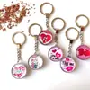 Accesorios creativos de llavero de cristal de doble cara, pequeños regalos, souvenirs turísticos, colgante de llavero, en stock en representación del cabello
