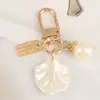 Chaveiro de Concha Fofo em Formato de Coração Presente Criativo Pequeno Joia Estilo Ins Pingente de Pérola Charm para AirPods
